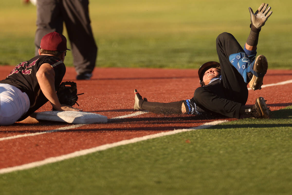Basic outfielder Troy Southisene (2) tumbles after sliding into first base safely against Faith ...