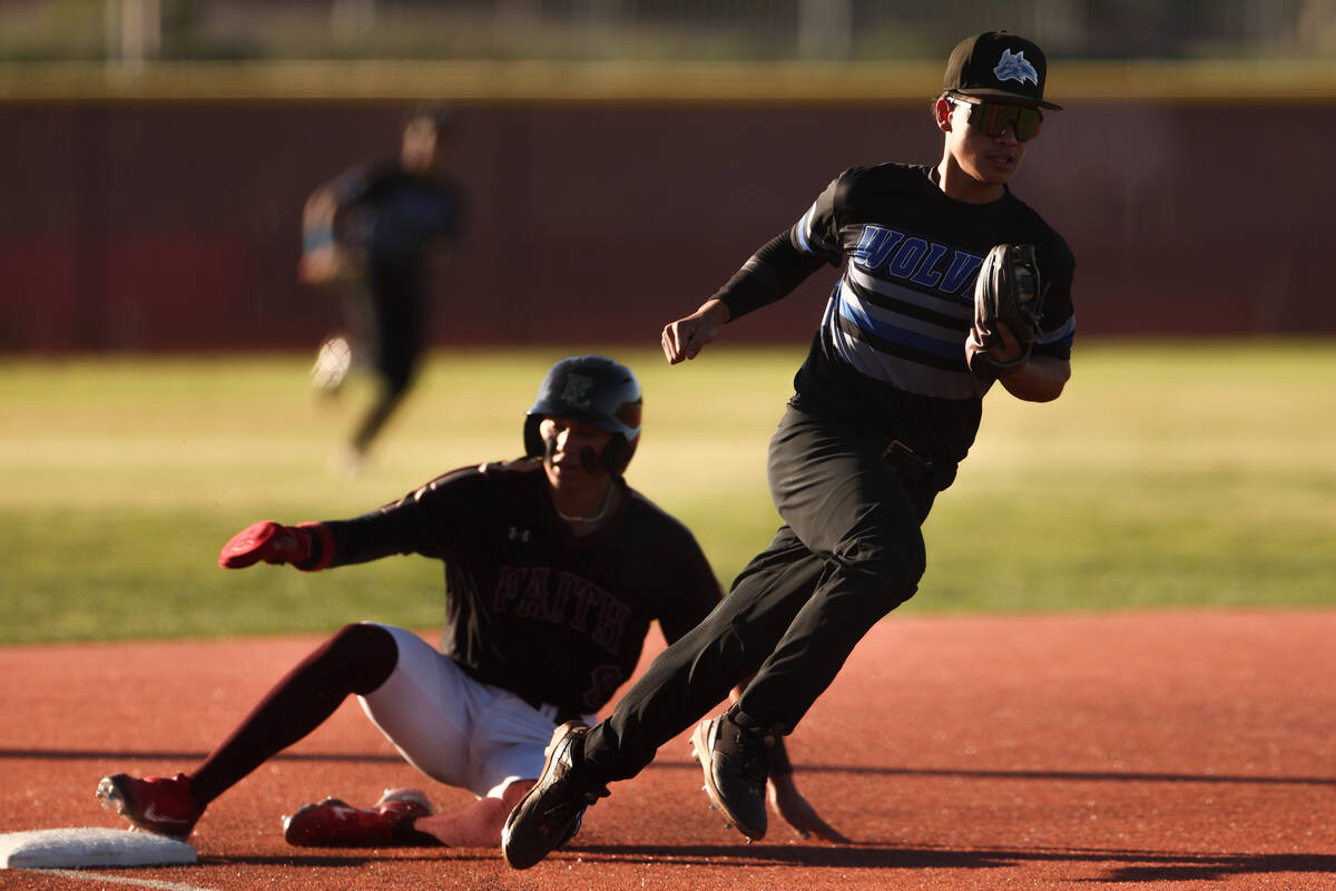 Basic third baseman Lyndon Lee (5) heads for the dugout after outing Faith Lutheran infielder K ...
