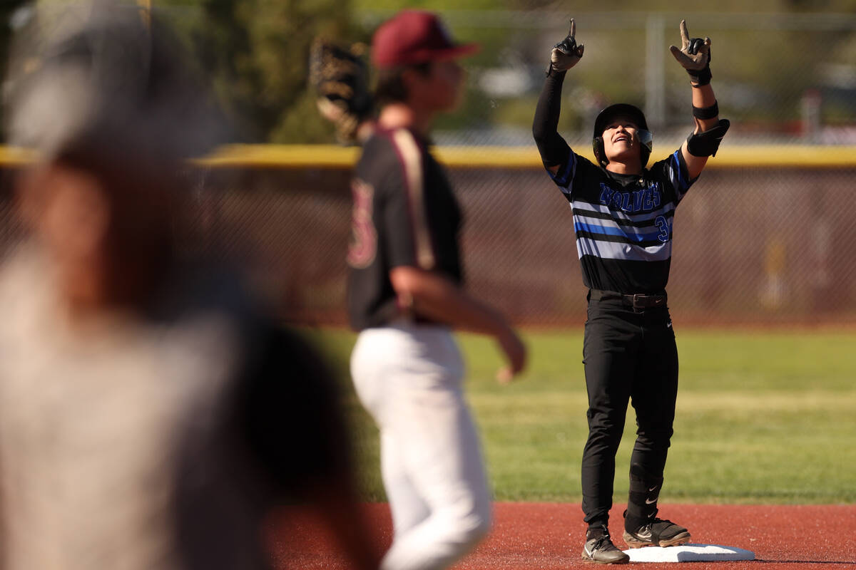 Basic shortstop Ty Southisene (3) gestures to the sky after scoring a double during a high scho ...