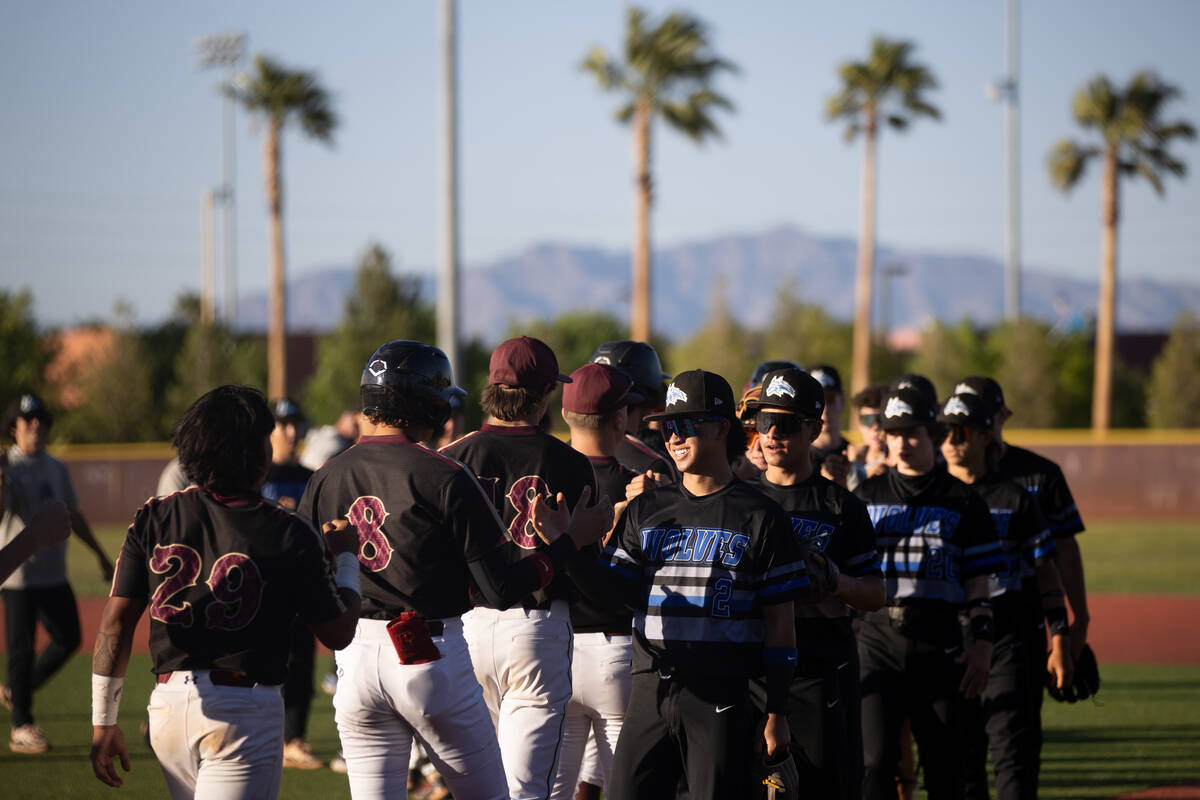 Basic slaps hands with Faith Lutheran after they won a high school baseball game on Tuesday, Ap ...