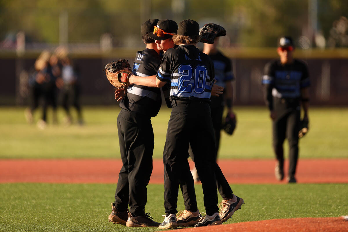 Basic embraces after winning a high school baseball game against Faith Lutheran on Tuesday, Apr ...