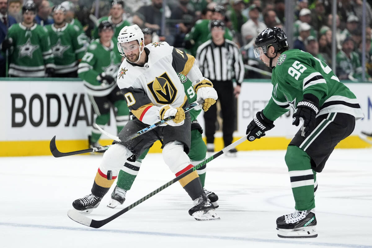 Vegas Golden Knights center Nicolas Roy (10) flips the puck forward over the stick of Dallas St ...