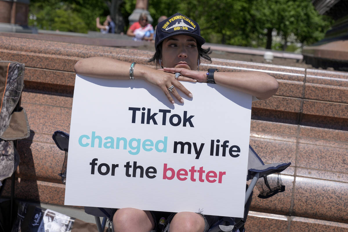 A TikTok content creator, sits outside the U.S. Capitol, Tuesday, April 23, 2024, in Washington ...
