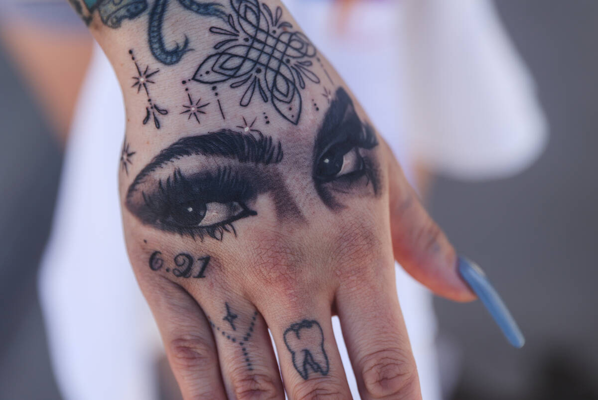 Alicia Lozoya, a friend of Tabatha Tozzi, shows her tattoo of Tozzi’s eyes on her hand a ...