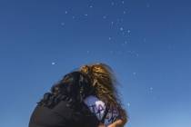 Regina Lacerda, mother of Tabatha Tozzi, is embraced by Ashley Galvan, best friend of Tozzi, at ...
