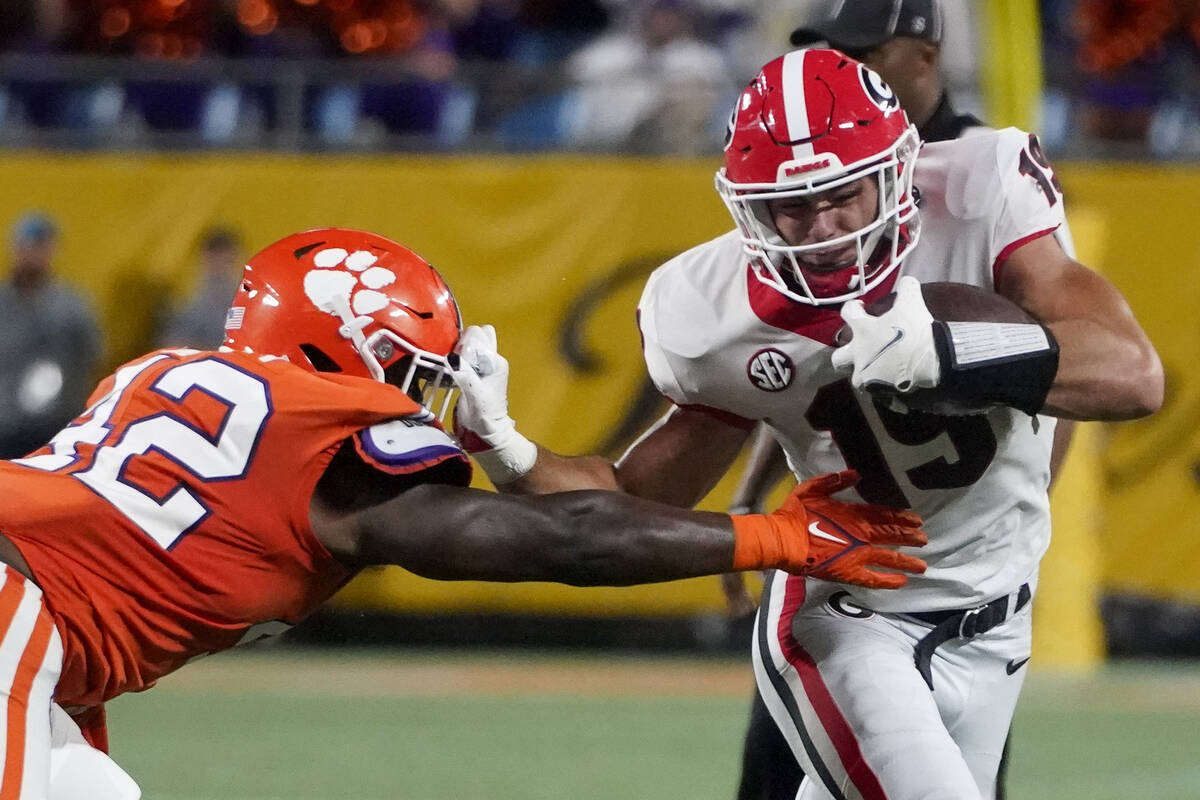 Georgia tight end Brock Bowers, right, pushes off Clemson linebacker LaVonta Bentley during the ...