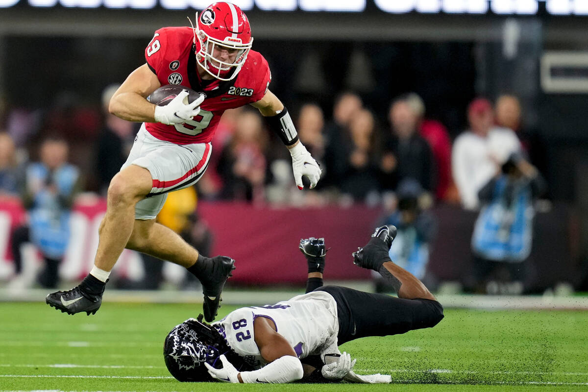 Georgia tight end Brock Bowers (19) leaps over TCU safety Millard Bradford (28) during the seco ...