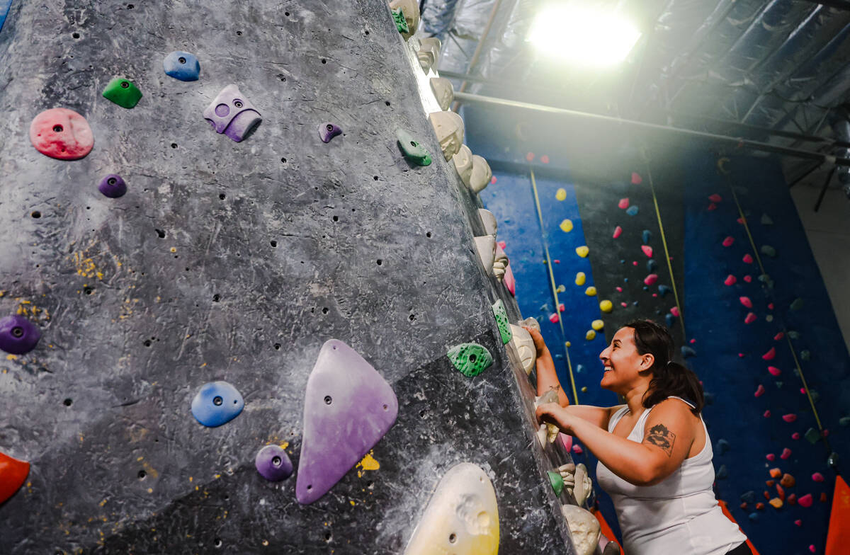 Andrea Villanueva free climbs a rock wall following a panel about outdoor recreational access, ...