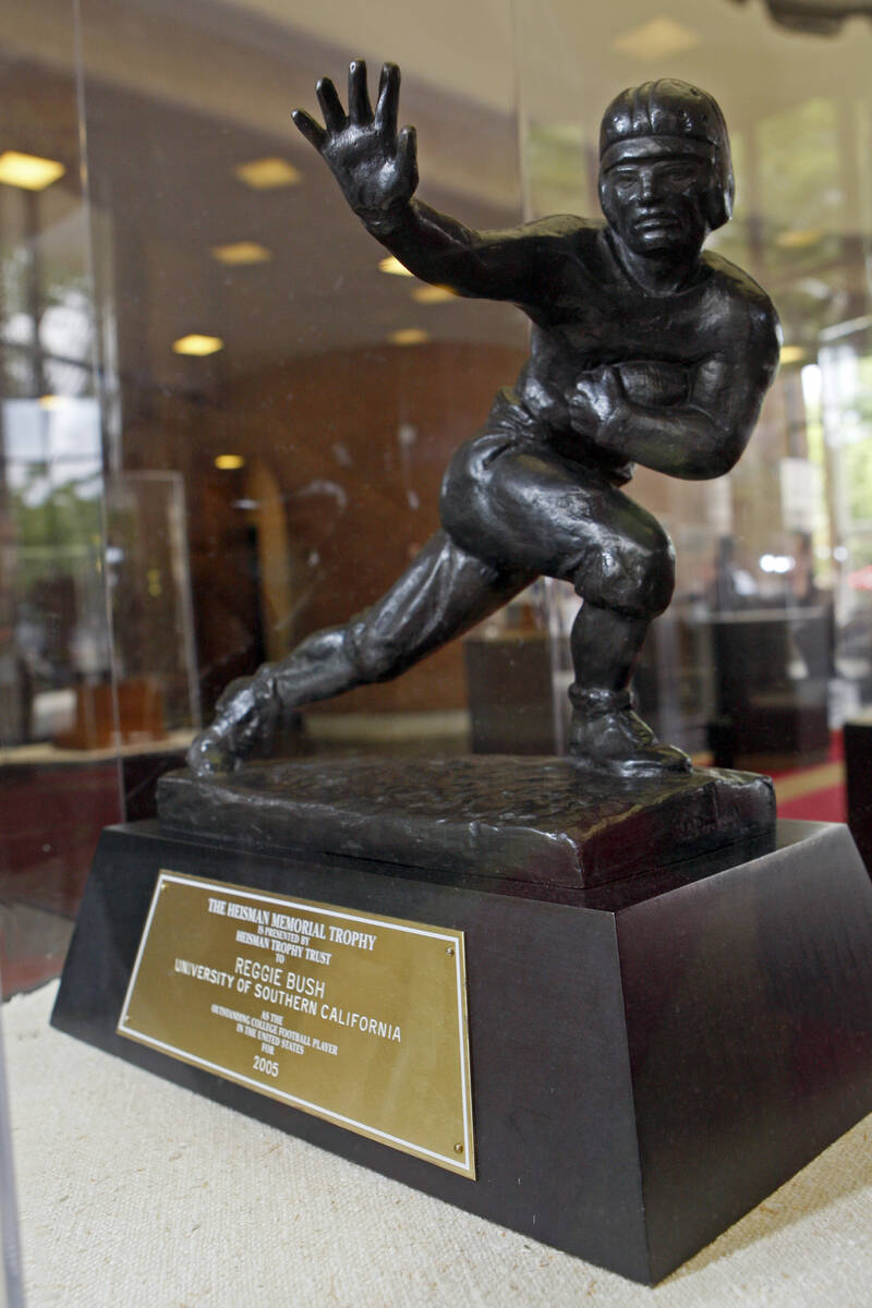 The Heisman Trophy, awarded to Reggie Bush in 2005, is seen in Heritage Hall during a meeting o ...