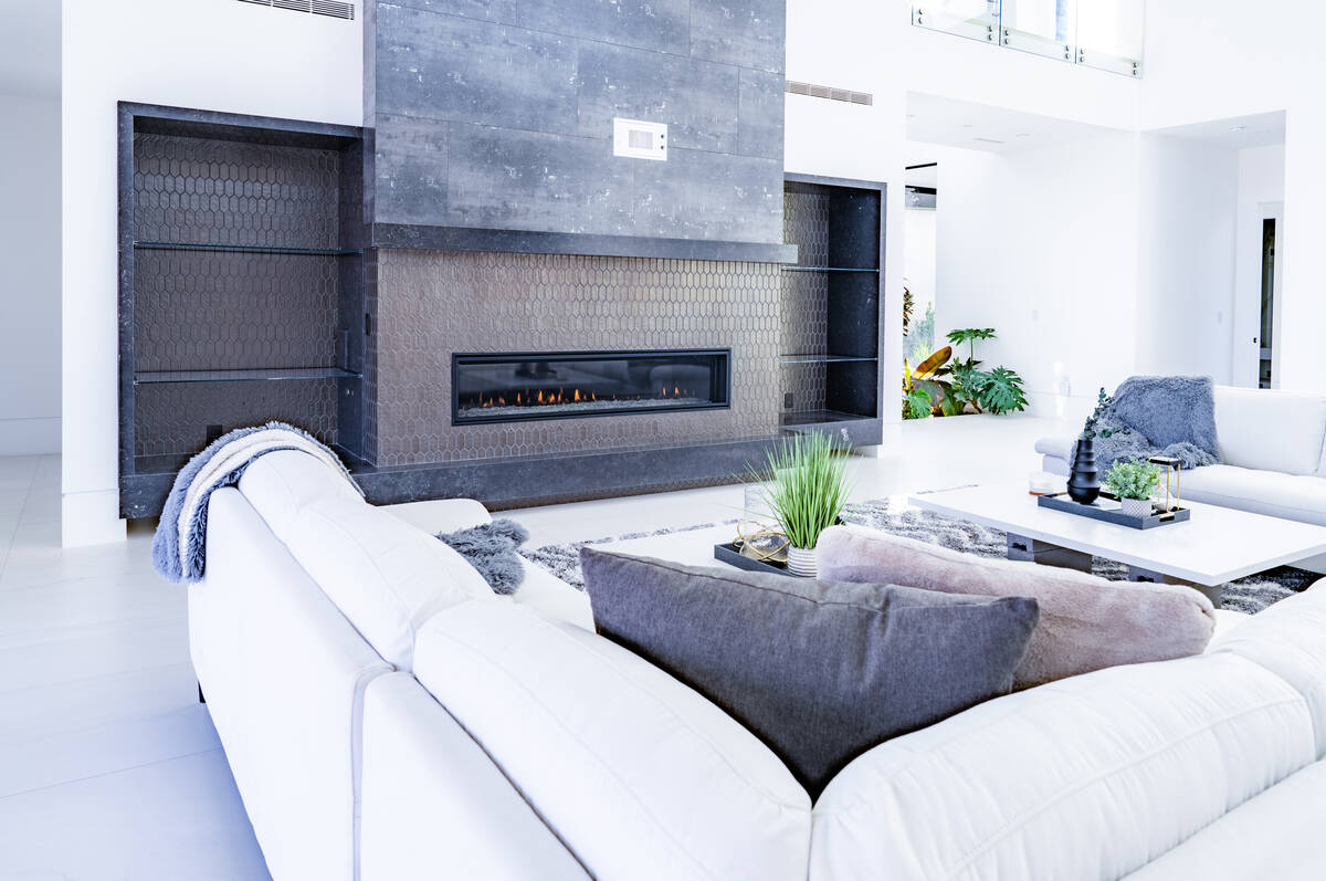 The living area showcases a striking fireplace. (Steve Smith/Pixel Boss Photography)