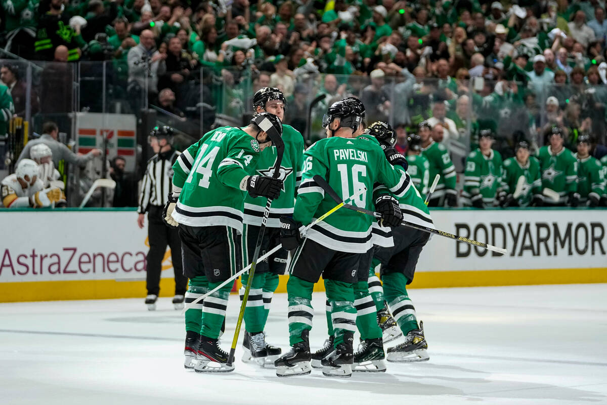 Dallas Stars players celebrate a first period power play goal by Jason Robertson, not visible, ...