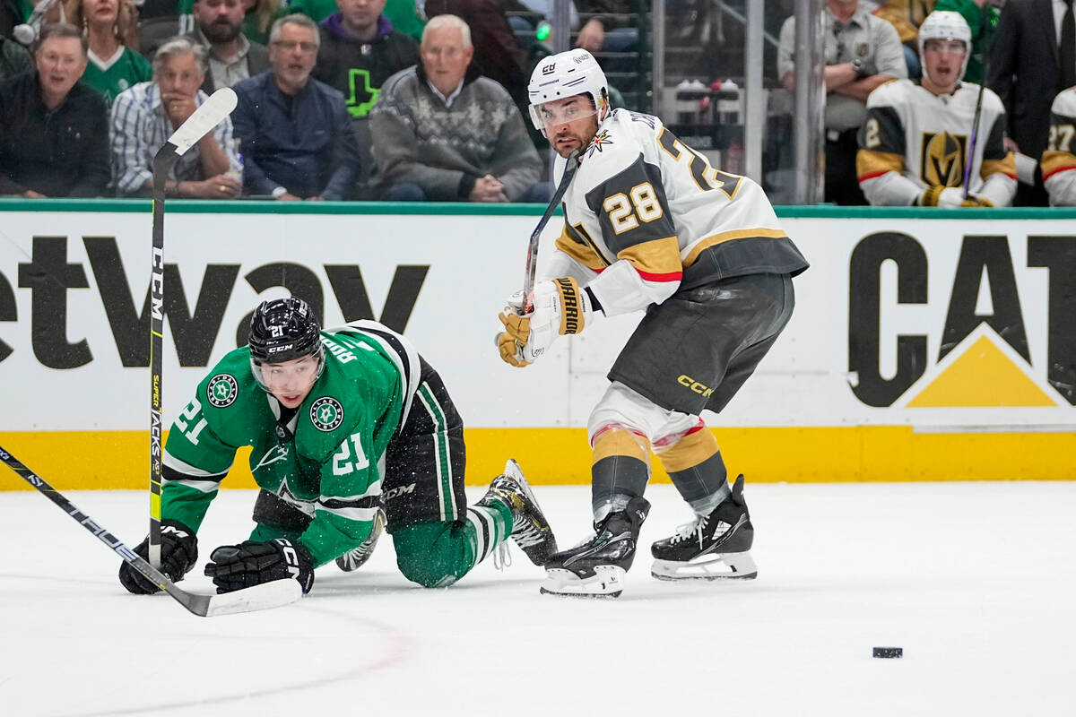 Dallas Stars left wing Jason Robertson (21) is tripped up by Vegas Golden Knights left wing Wil ...