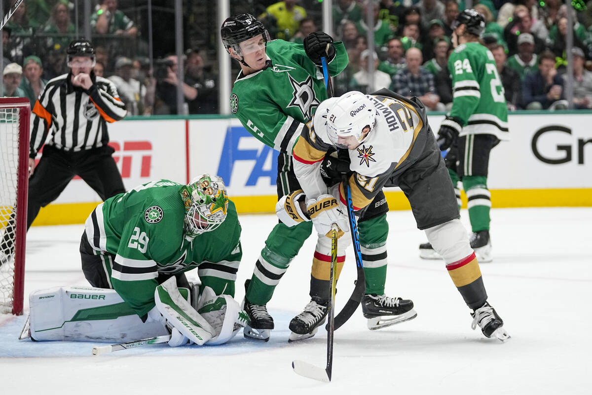 Dallas Stars goaltender Jake Oettinger (29) collects the puck as teammate Nils Lundkvist (5) de ...