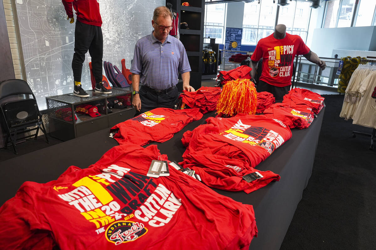 A customer looks over Caitlin Clark merchandise in the Indiana Fever team store in Indianapolis ...