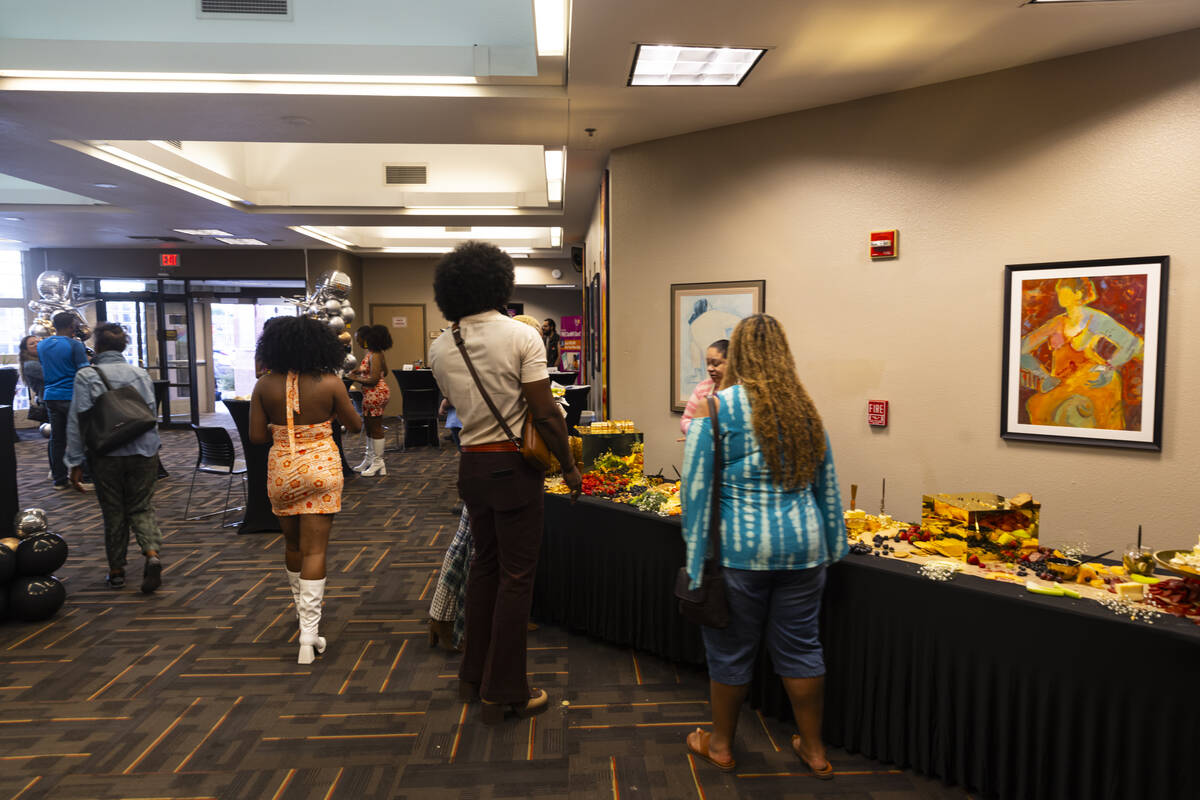 Attendees snack on food during an event celebrating the 50th anniversary of the West Las Vegas ...