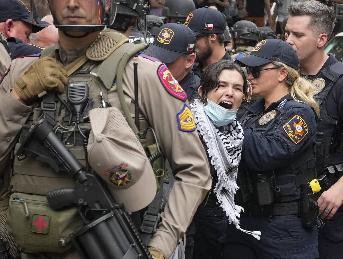 A woman is arrested at a pro-Palestinian protest at the University of Texas, Wednesday, April 2 ...