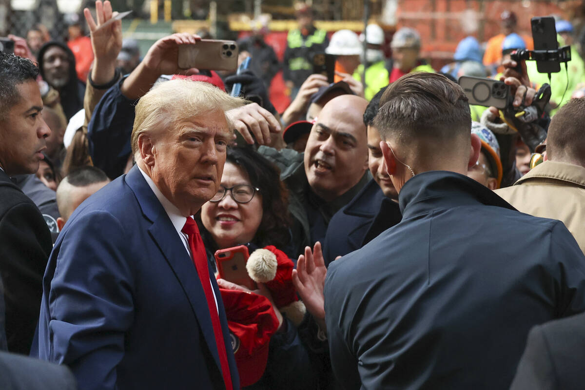 Former President Donald Trump speaks with union representatives at the construction site of the ...