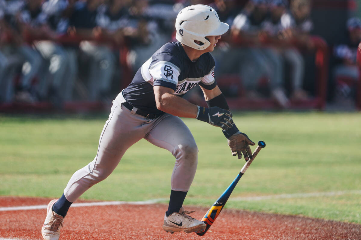 Shadow Ridge’s Evan Noble (1) drops the bat as he takes off to first base during a high schoo ...