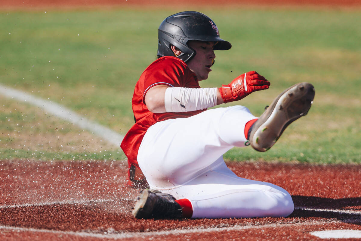 Las Vegas’ Justin Romero (26) slides to home base during a high school baseball game bet ...