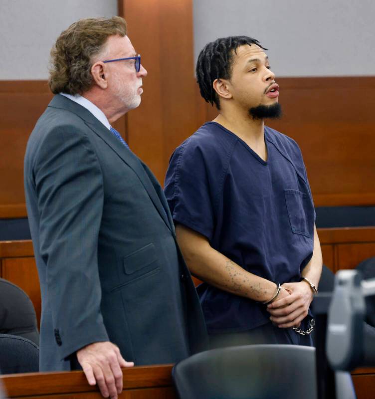 Terrell Rhodes, right, answers District Court judge Jacqueline Bluth's questions as he appears ...