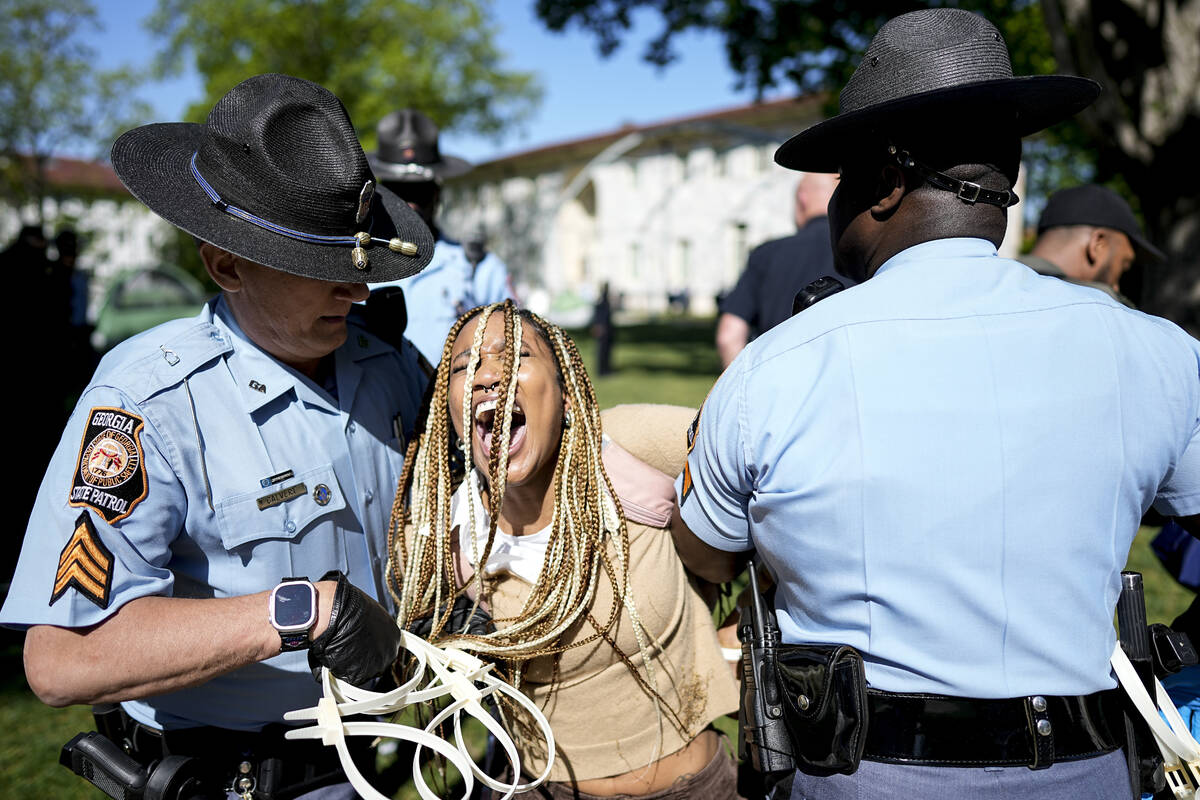 Georgia State Patrol officers detain a demonstrator on the campus of Emory University during a ...