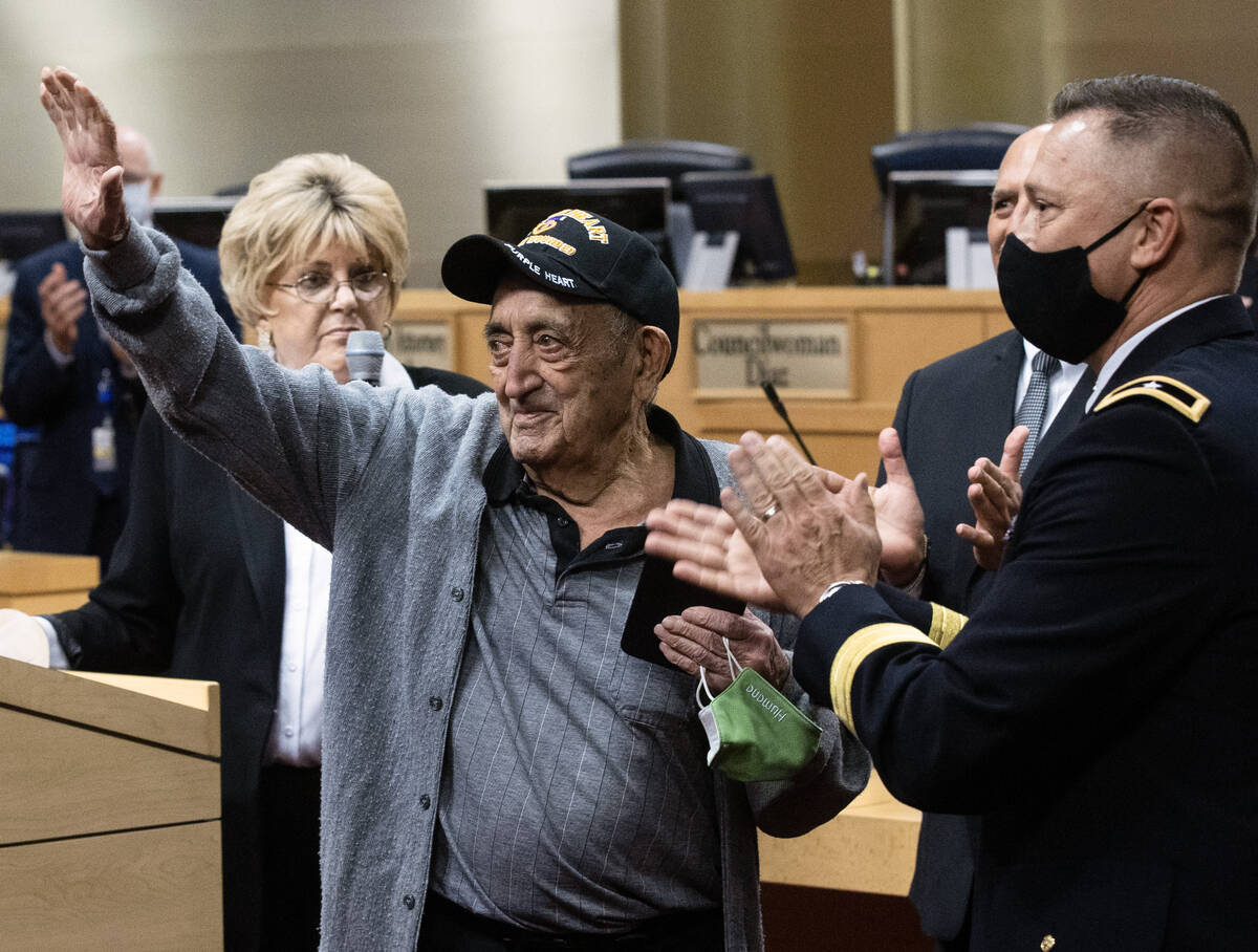 A 98-year-old World War II veteran, Onofrio ÒNo-NoÓ Zicari, left, acknowledges the cr ...