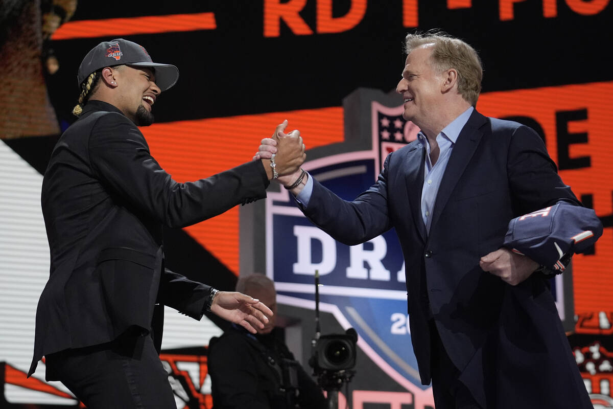 Washington wide receiver Rome Odunze embraces NFL Commissioner Roger Goodell after being chosen ...
