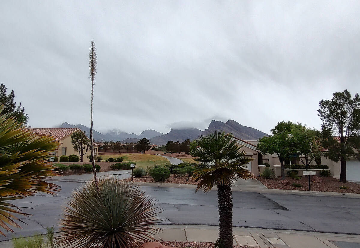 Rain clouds obscure some of the hills on the west side of the Las Vegas Valley shortly before n ...