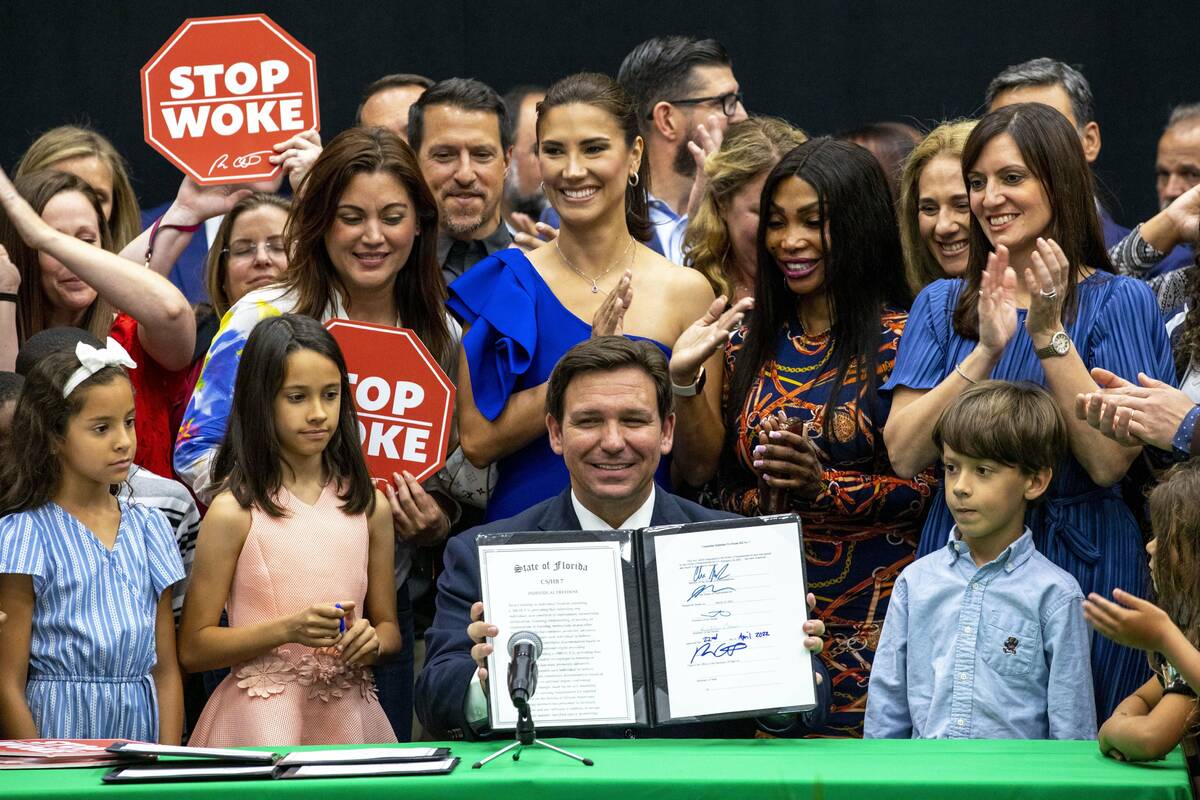 FILE - Florida Gov. Ron DeSantis smiles after publicly signing HB7, "individual freedom," also ...