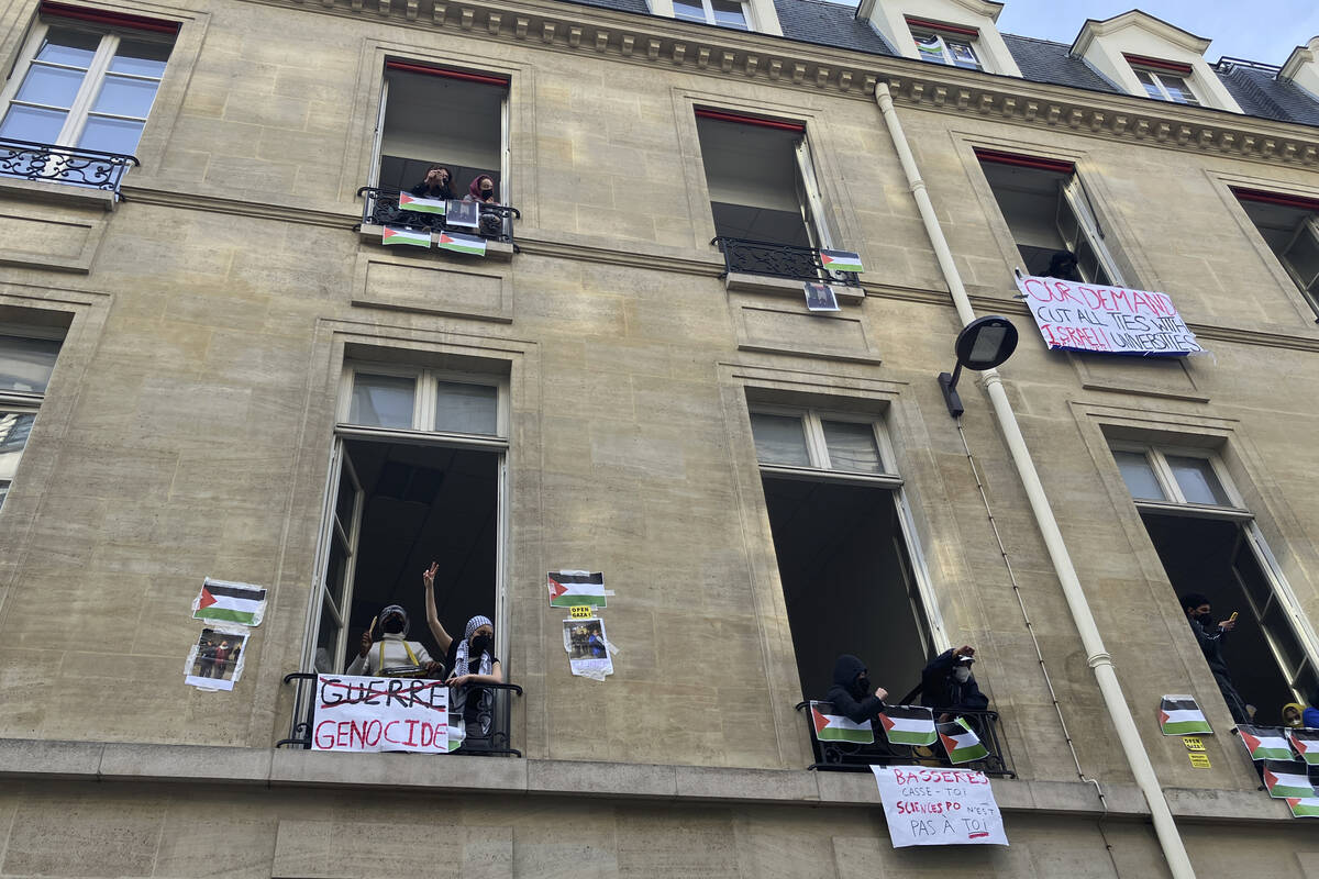 Students blocking the Sciences Po university look out Friday, April 26, 2024 in Paris. (AP Phot ...
