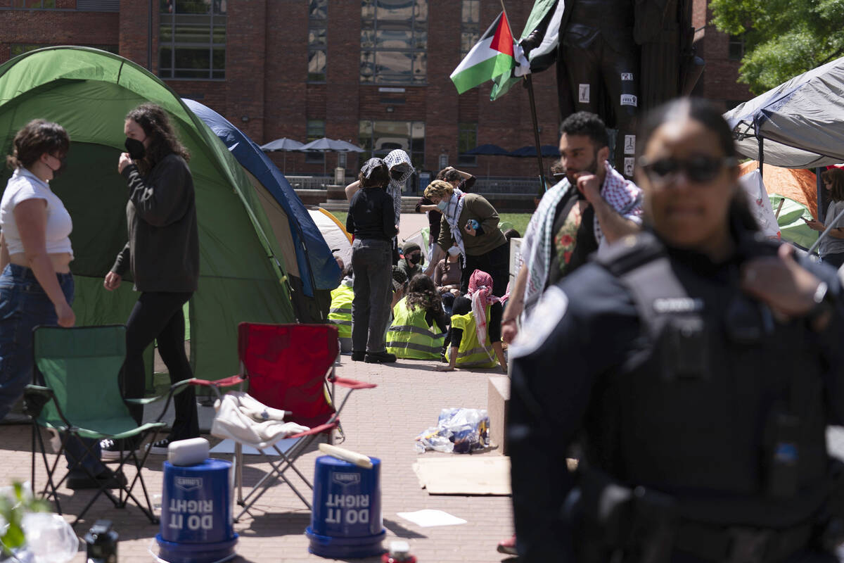 George Washington University police close a student encampment as students demonstrate during a ...