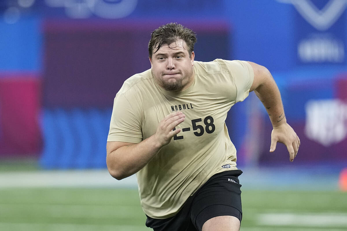 Oregon offensive lineman Jackson Powers-Johnson runs a drill at the NFL football scouting combi ...