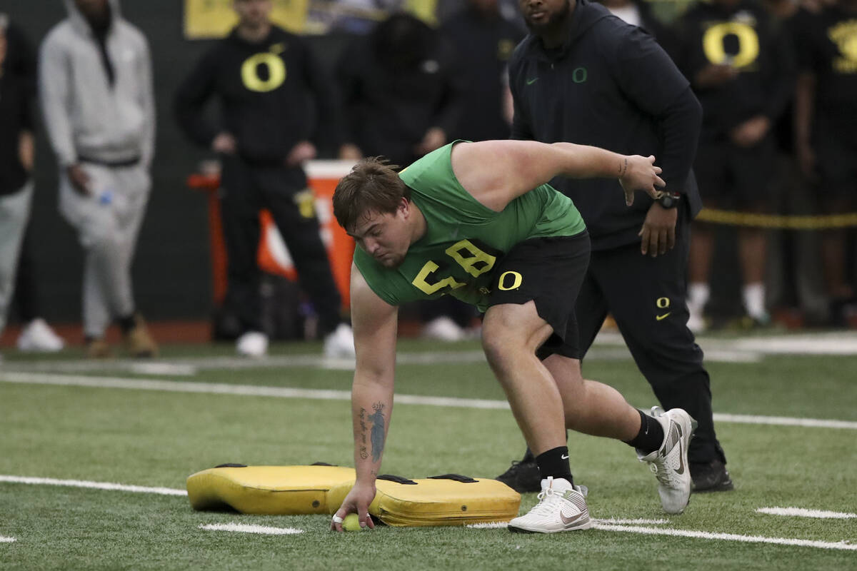 Oregon offensive lineman Jackson Powers-Johnson (58) participates in a position drill at the sc ...