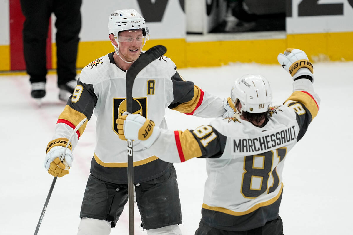 Vegas Golden Knights center Jack Eichel, left, celebrates his empty net goal with Jonathan Marc ...