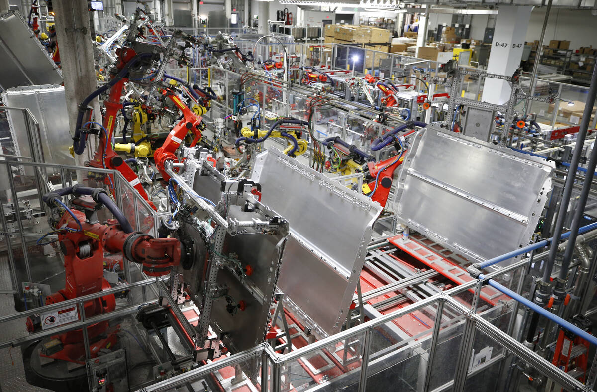 Robots work in many areas of the Tesla Gigafactory, east of Reno, Nev., on Tuesday, Dec. 4, 201 ...