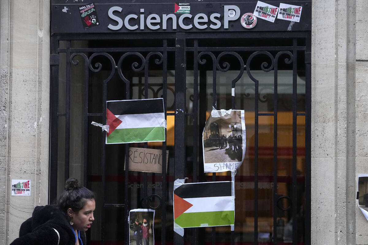 A student walks past th entrance of Sciences-Po university in Paris Friday, April 26, 2024. Stu ...