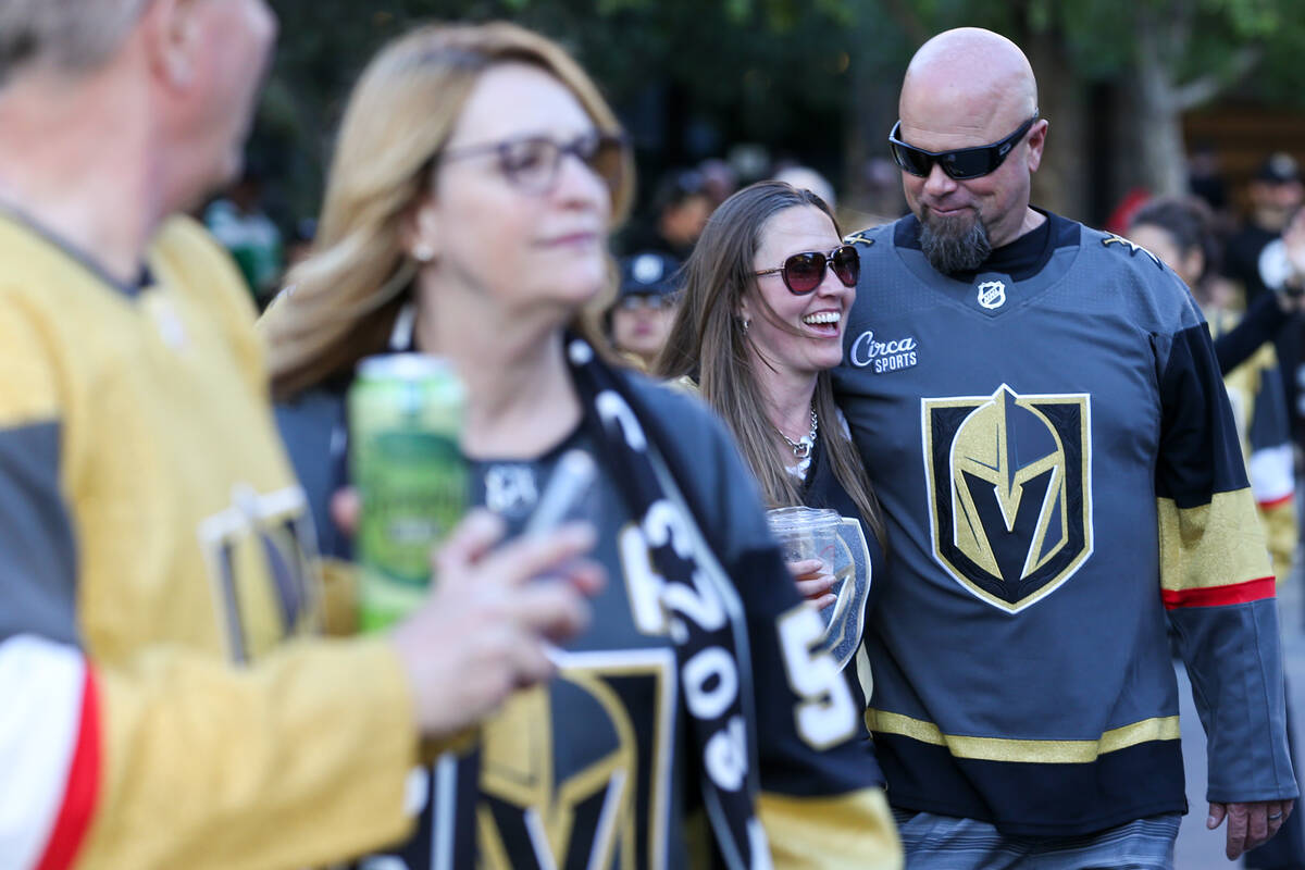 Golden Knights fans walk toward T-Mobile Arena before Game 3 of an NHL hockey Stanley Cup first ...