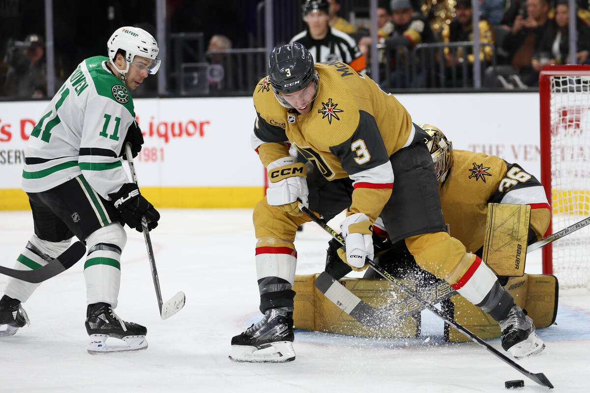 Golden Knights defenseman Brayden McNabb (3) gets the puck away from the net while Stars center ...