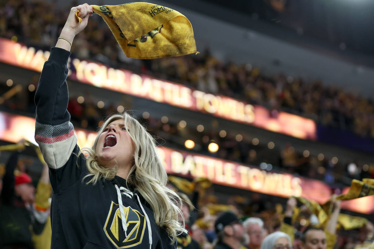 A Golden Knights fan cheers for her team during overtime in Game 3 of an NHL hockey Stanley Cup ...