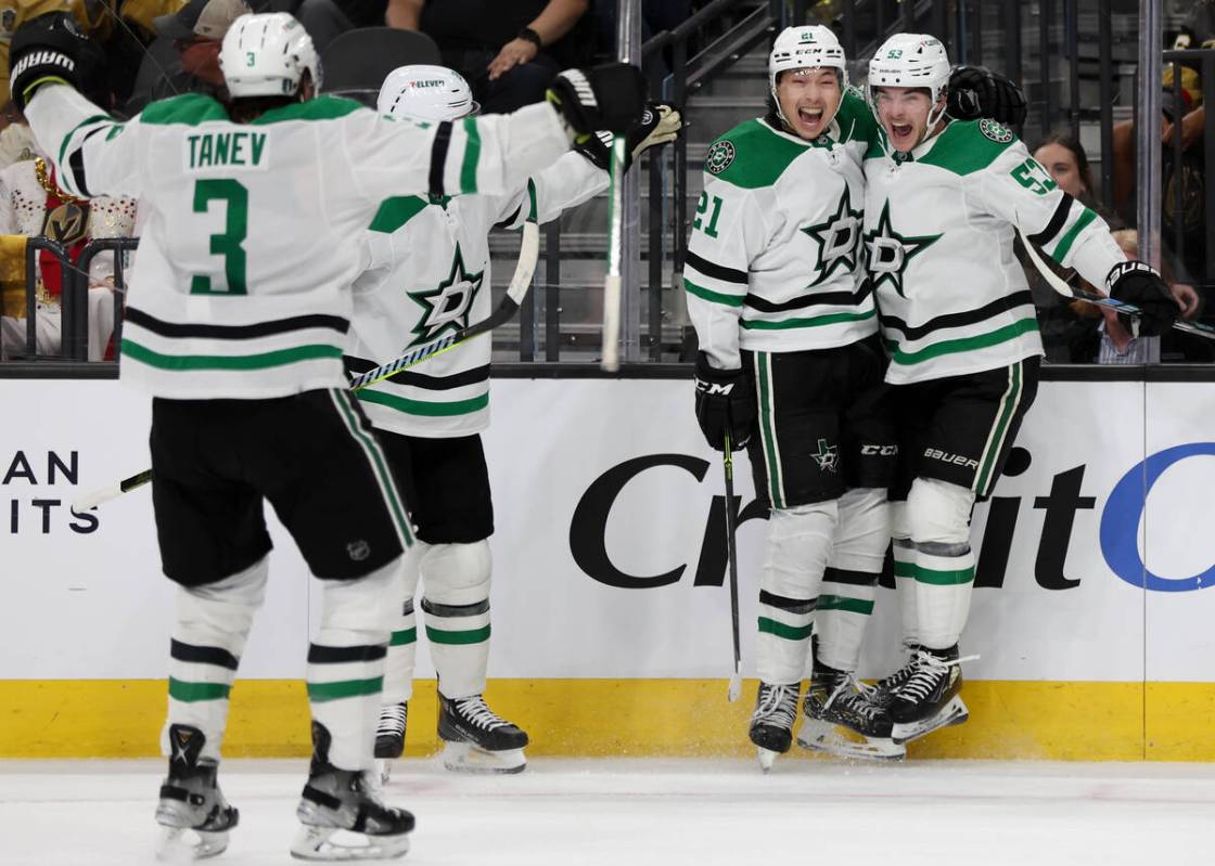 Stars left wing Jason Robertson (21) and center Wyatt Johnston (53) celebrate as they win durin ...