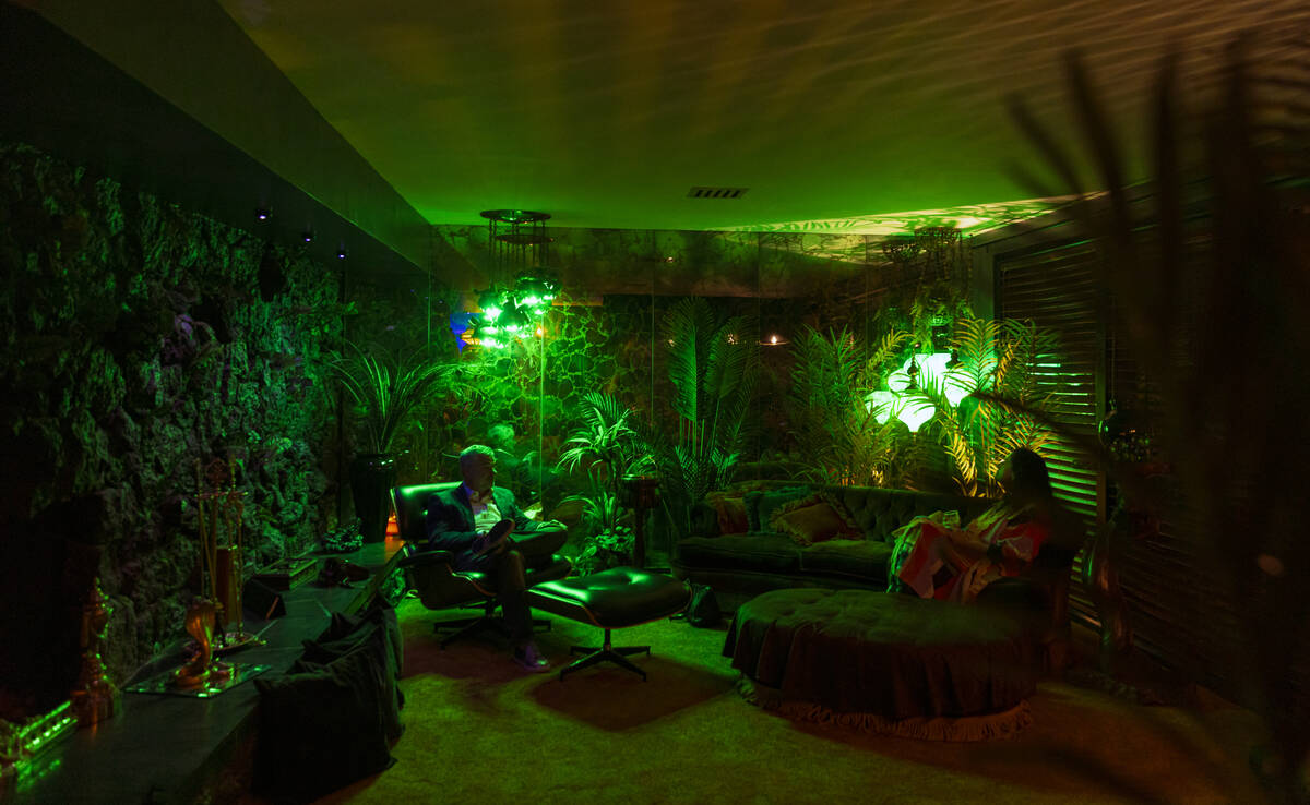 People relax during an evening party at a Beverly Green home called “Lava House” ...