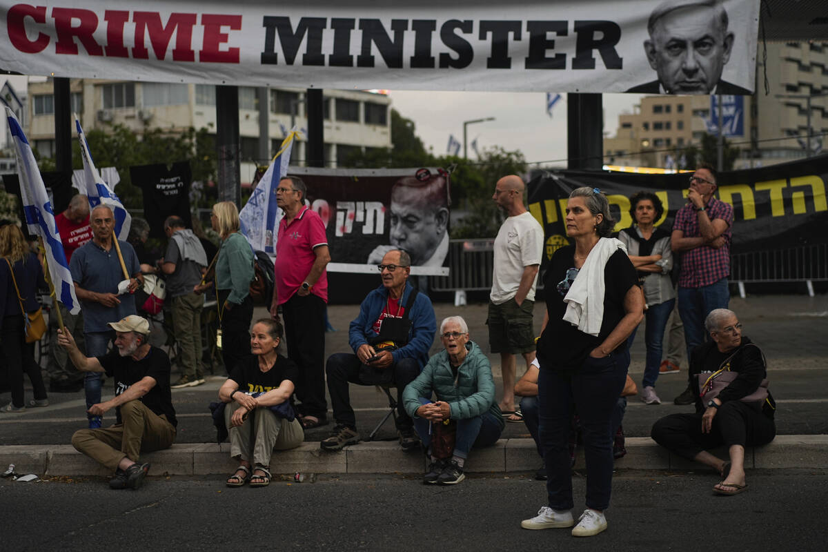 People protest against Israeli Prime Minister Benjamin Netanyahu's government in Tel Aviv, Isra ...