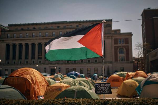 A Palestinian flag flutters in the wind during a pro-Palestinian encampment, advocating for fin ...