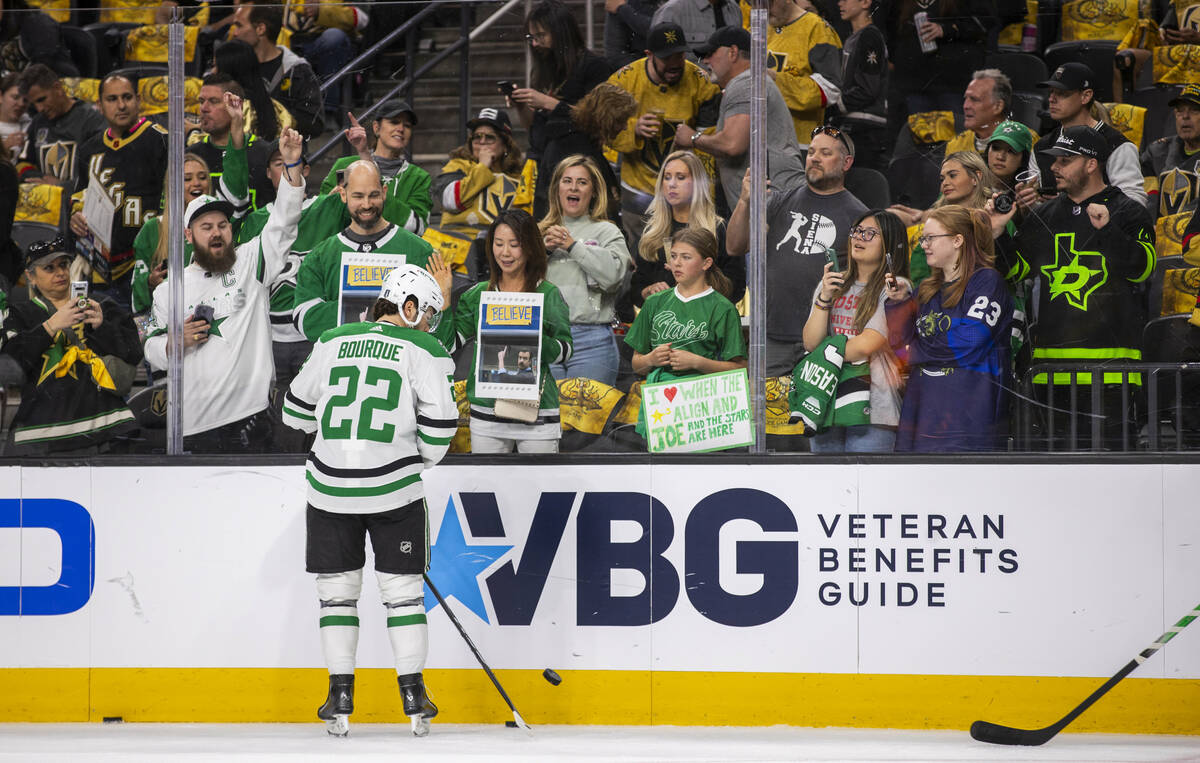 Dallas Stars center Mavrik Bourque (22) flicks up a puck to toss to the fans during warm ups in ...