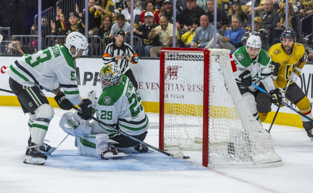 Dallas Stars goaltender Jake Oettinger (29) has the puck get past him as center Wyatt Johnston ...