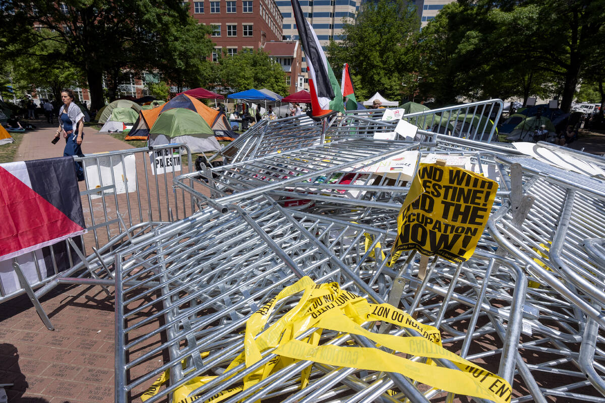 Barricades torn down by demonstrators are piled in the center of an encampment by students prot ...