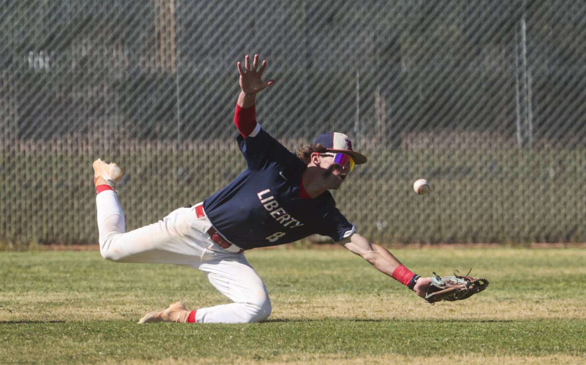Liberty outfielder Jacob Damore comes up short on the catch during a baseball game against Spri ...
