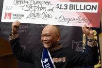 Cheng "Charlie" Saephan holds a display check during a news conference at the Oregon Lottery he ...