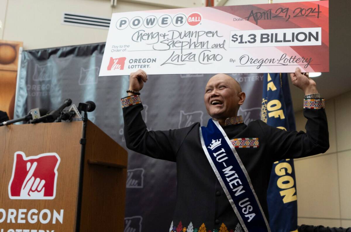 Cheng "Charlie" Saephan holds a display check during a news conference at the Oregon Lottery he ...