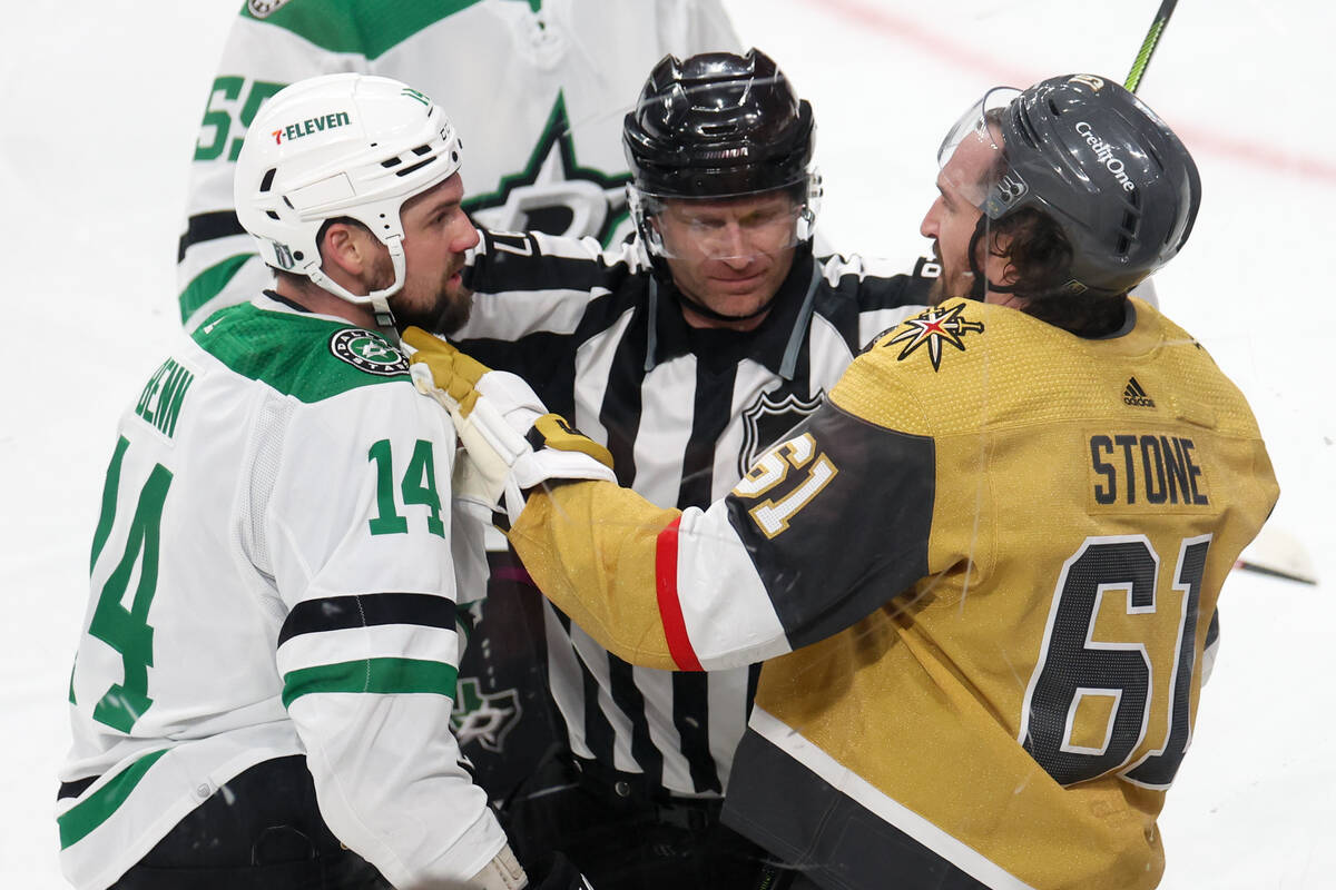 A referee separates Stars left wing Jamie Benn (14) and Golden Knights right wing Mark Stone (6 ...